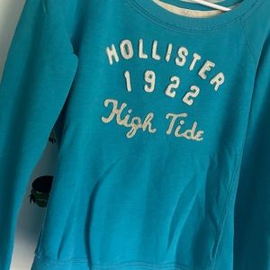 woman’s blue long sleeve hollister shirt